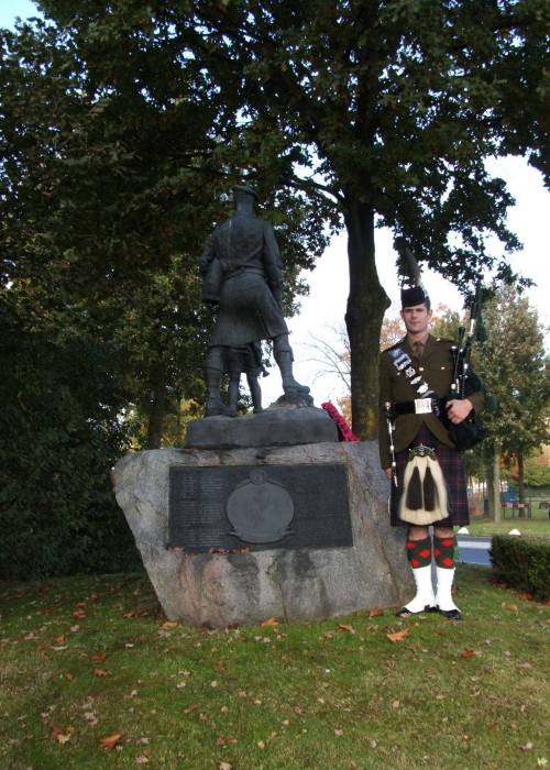 Piper Peter Grant of The Highlanders, standing at the Highland Division memorial at Schijndel, Holland, October 2009. The 65th Anniversary of Liberation.