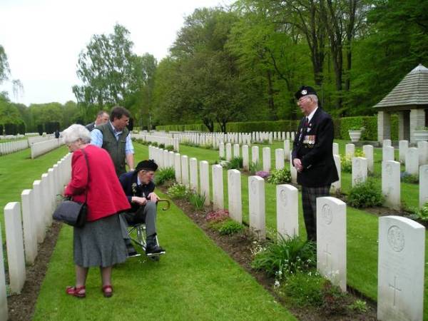 George Sands reading the name of a fallen Cameron. Reichswald war cemetery, Germany